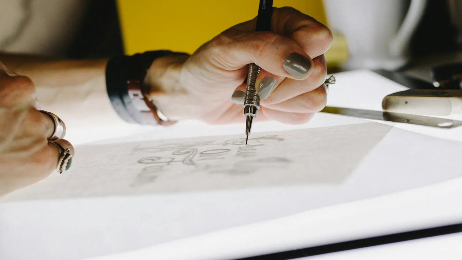 Designer sketching lettering with a pencil