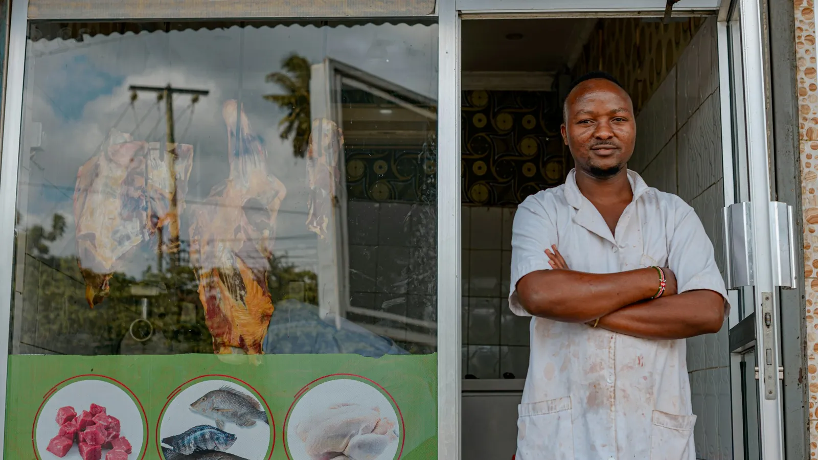 Business owner standing in the doorway of his storefront