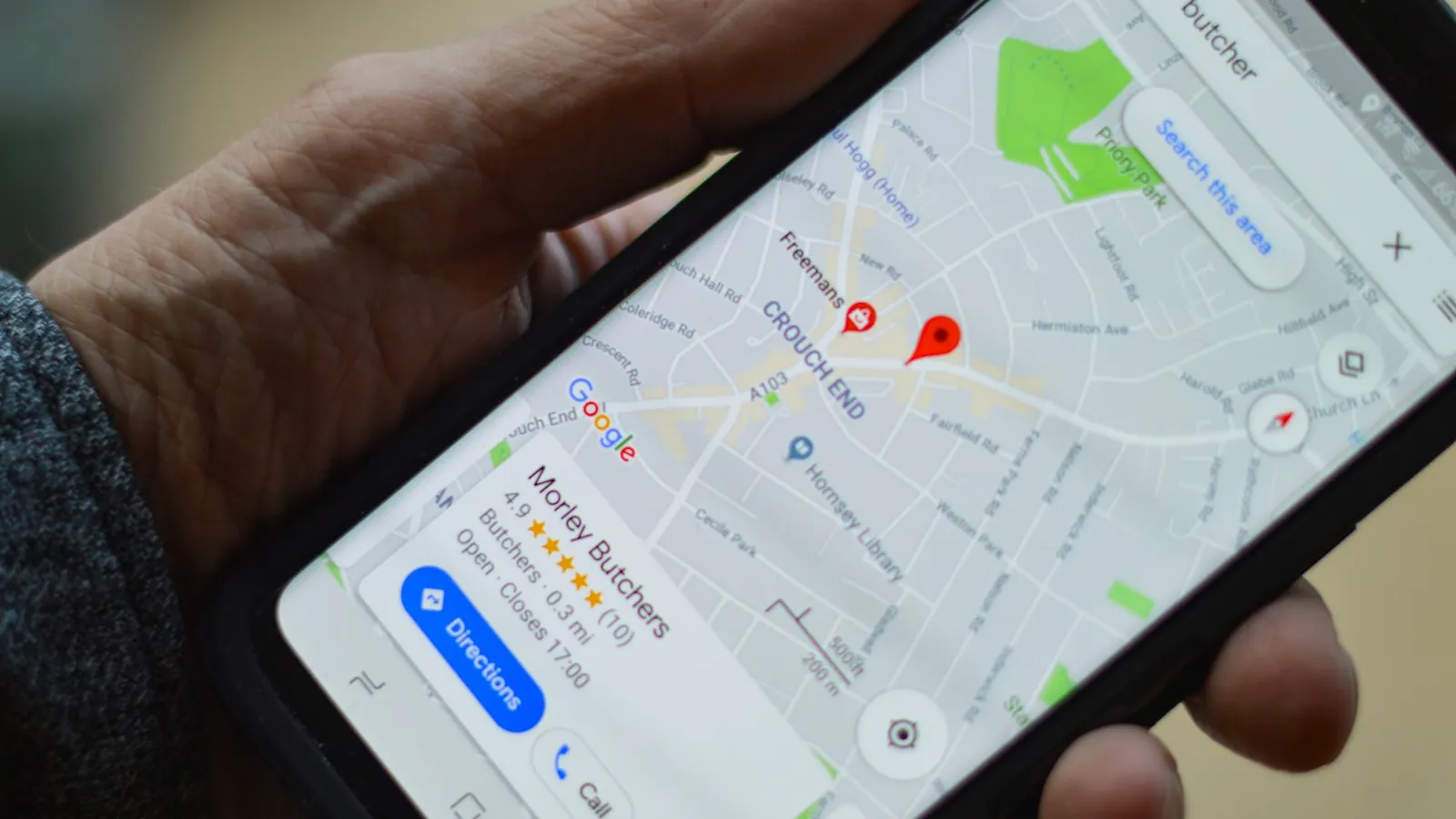 Phone showing a Google Maps business listing with reviews and directions