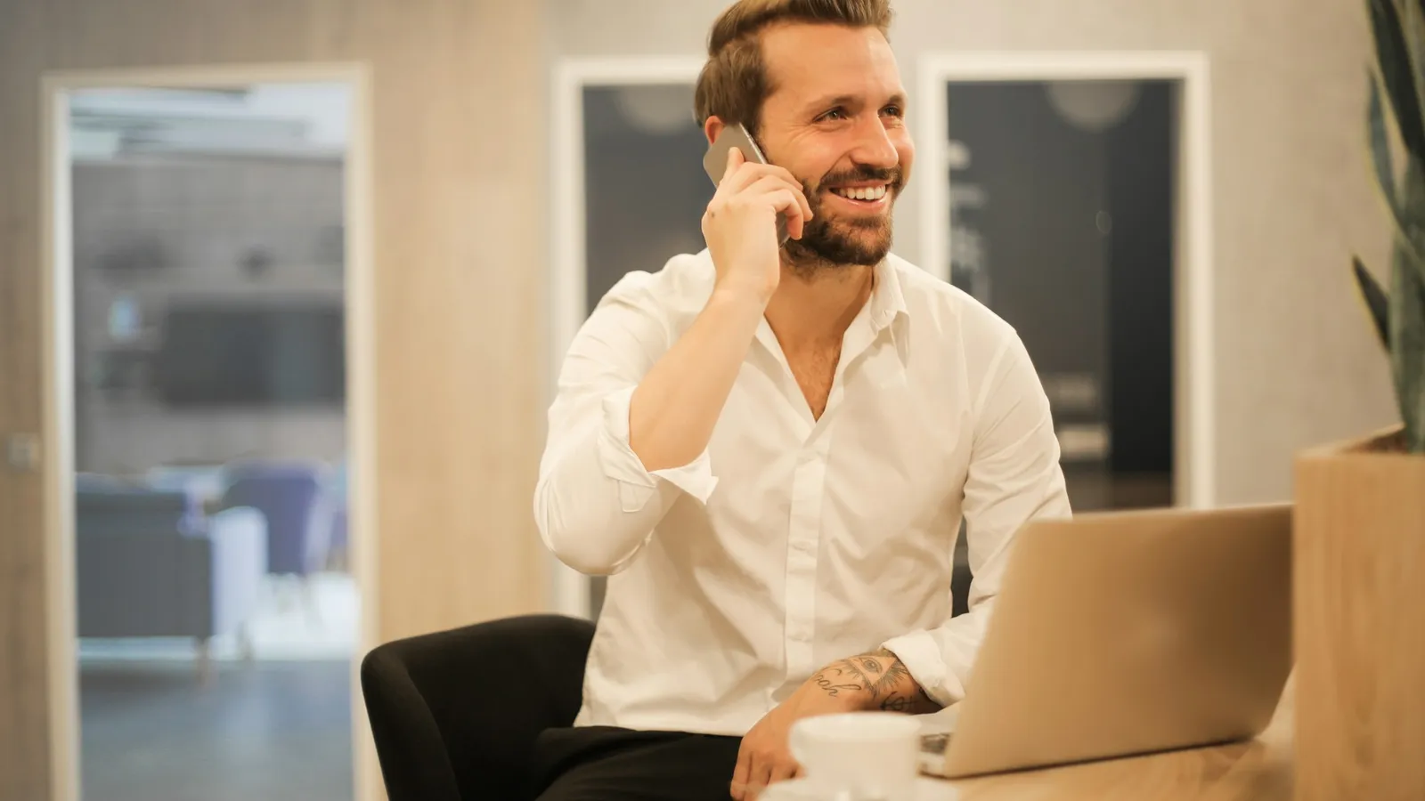Man sitting in a chair talking on his phone