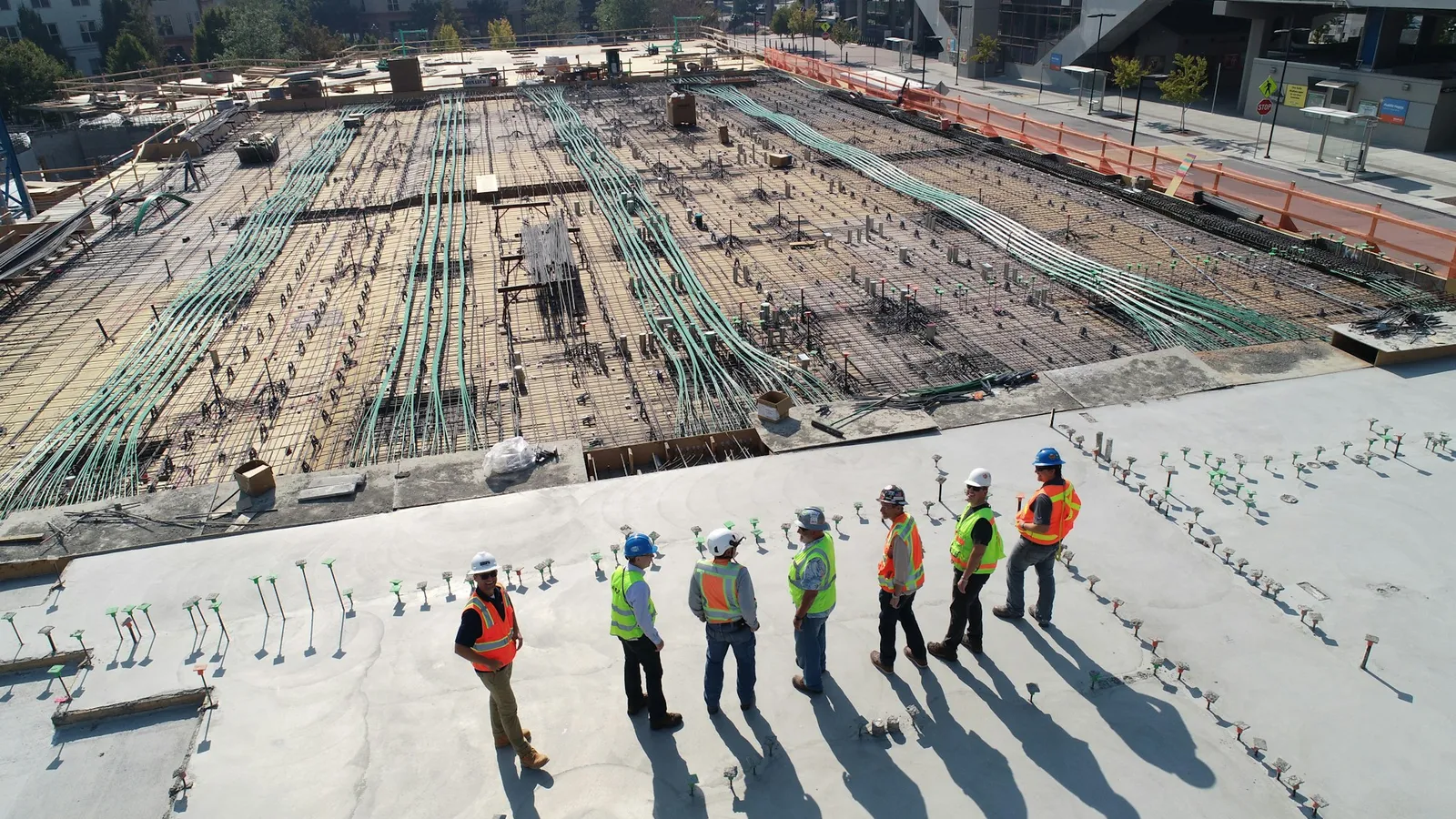 Construction crew in hard hats standing on a job site