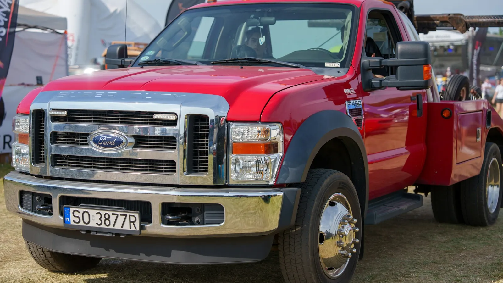 Red tow truck parked and ready for a call